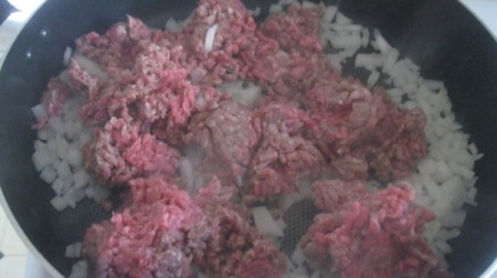 cooking meat & onion in pan