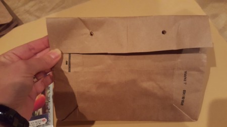 Folding the paper bag into an envelope.