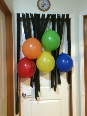 A birthday banner with balloons and streamers.