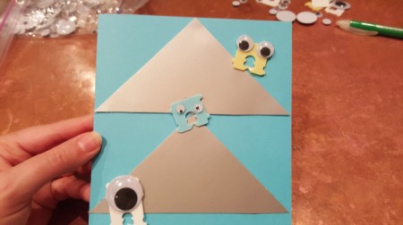 Googly eye monsters on the front of a card.