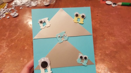 Googly eye monsters on the front of a card.