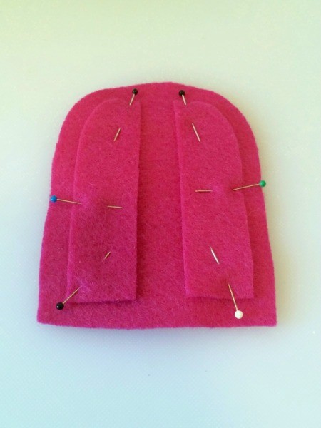 Pinning the pieces of felt to each other.