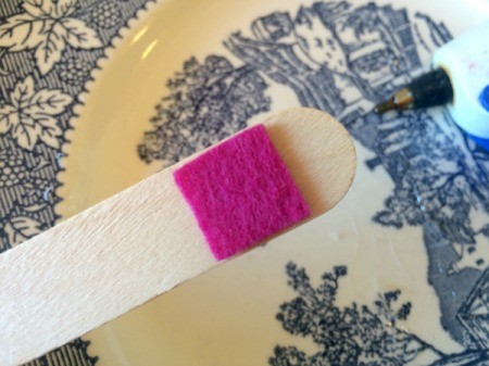 A popsicle stick with a piece of colored felt at the bottom.