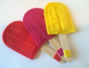 Three different colored popsicle with matching sticks.