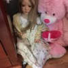 doll next to a pink stuffed bear