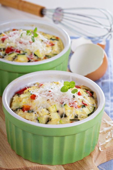two baking dishes with veggie omelettes