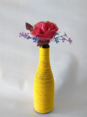 yellow yarn wrapped bottle with flower