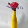 yellow yarn wrapped bottle with flower