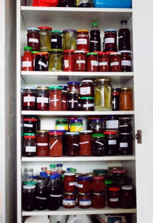 A fully stocked pantry with canned goods.