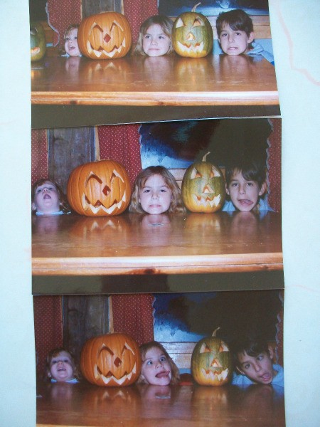 Three kids posing with jack o'lanterns