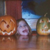 Three kids posing with jack o'lanterns