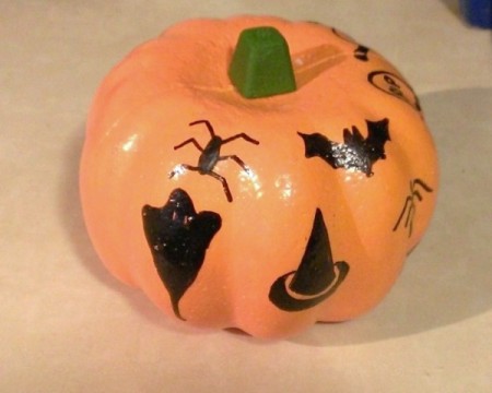 A foam pumpkin with marking pen decorations.