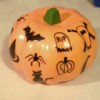 A foam pumpkin with marking pen decorations.