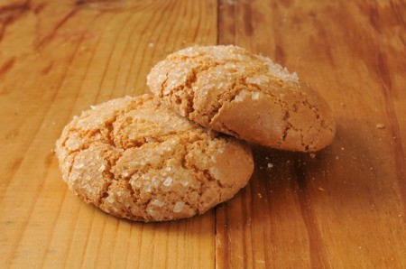 two molasses cookies on a wooden table