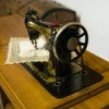 vintage sewing machine in wooden cabinet