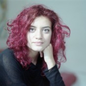 girl with curly dyed red hair