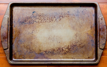A used cookie sheet in need of cleaning.