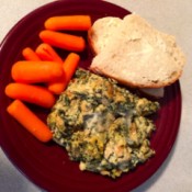 A dish of crockpot spinach artichoke chicken.