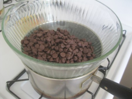 Chocolate chips in a glass bowl over a pot of water for melting.