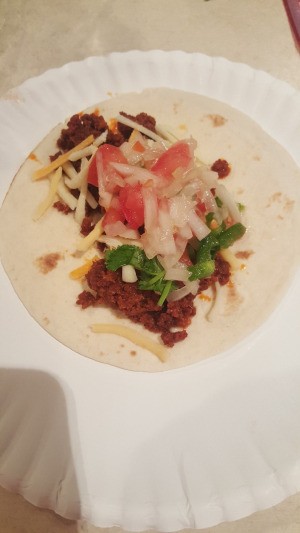 A taco made with chorizo and flour tortillas.