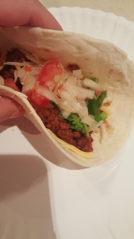 A taco made with chorizo and flour tortillas.