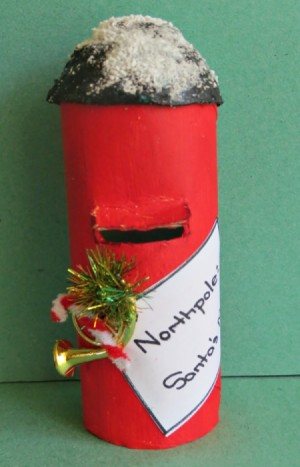A paper tube Santa mailbox, colored red.