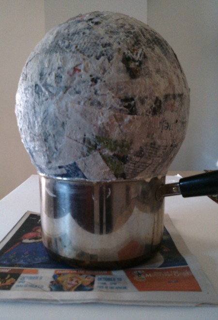 Making a balloon covered in paper-maché.