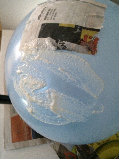 Making a balloon covered in paper-maché.