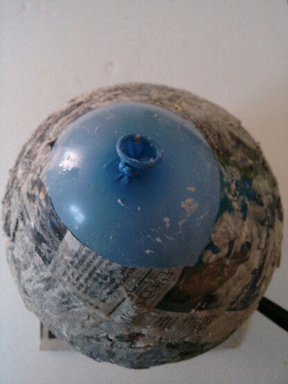 Making a balloon covered in paper-maché.