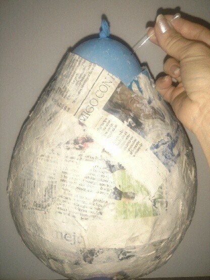 Making a balloon covered in paper-maché.