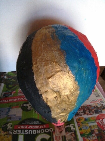 A balloon covered with painted paper-maché.