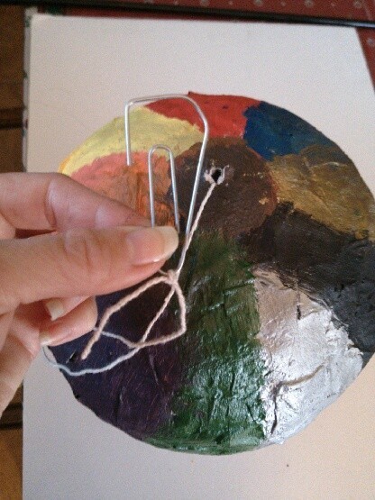 Attaching the ropes to the bottom of a hot air balloon craft.