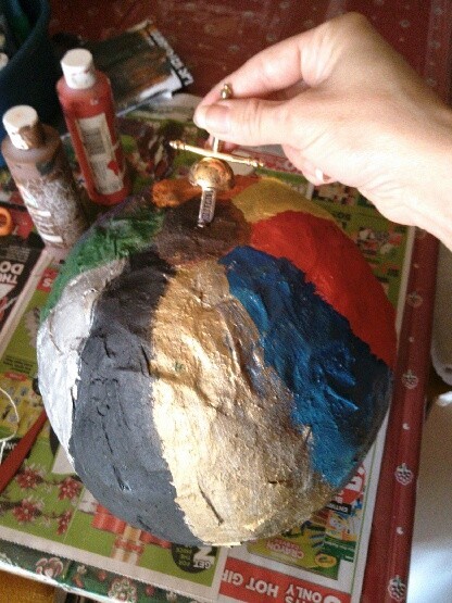 Poking a hole in the top of the balloon.