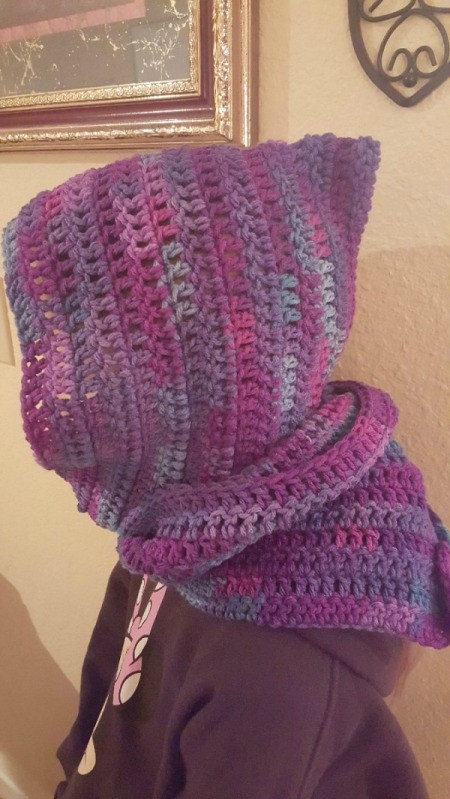 side view of girl wearing hooded scarf with ends wrapped around her neck