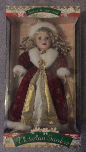 doll in fancy red cape with white fur trim