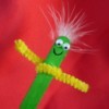 green stick puppet with yellow pipe cleaner arms