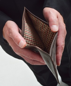 A man holding open an empty wallet.