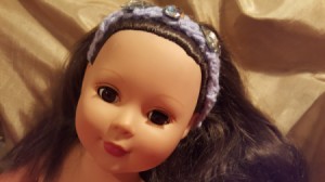 closeup of doll wearing the finished headband