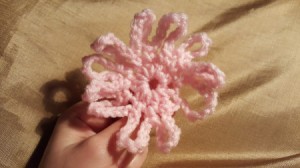 A completed crocheted loopy flower.