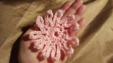 A completed crocheted loopy flower.