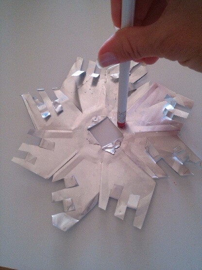 use a pencil eraser to flatten the folded triangles