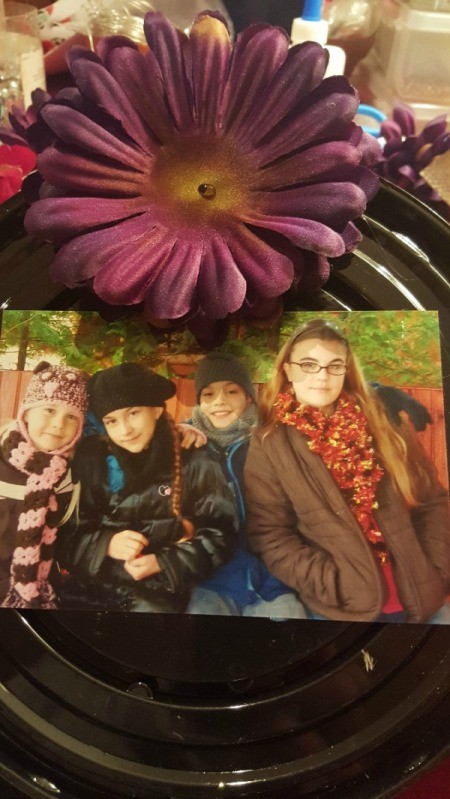 begin arranging flowers around the platter and center photo