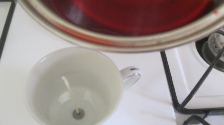 Teacup Candle - pouring leftover wax into cup with wick
