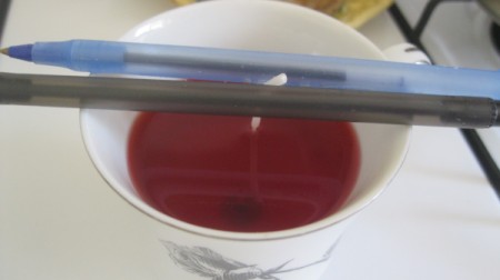 Teacup Candle - after adding wax use pencils or pens to hold wick in place