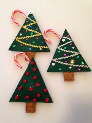 two sequin and one pom pom decorated felt Christmas tree treat holders