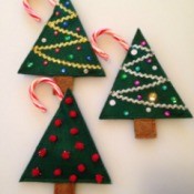 two sequin and one pom pom decorated felt Christmas tree treat holders