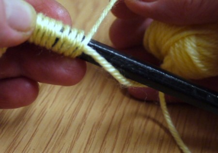 Yarn Flower Hair Clip - begin wrapping the rest of the yarn around the piece laying against the pencil 40 times