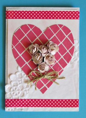 A Valentine's day card with a heart, mesh, lace and flowers.