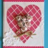 A Valentine's day card with a heart, mesh, lace and flowers.