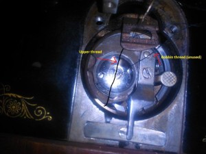 A bobbin in a Singer sewing machine.